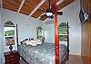 The master bedroom boasts a caribbean style four poster bed, a low-profile split a/c unit and wonderful views!