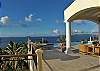 On the upper level, the Great Room opens on to the pool veranda, which provides ample shade for relaxing and reading. Beyond lies the forty foot long infinity edge pool.