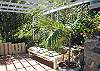 To the other side of the living room is the cooking and utility wing where the guest laundry is located. Here an outside bench provides a quiet place to relax while cooking out on the gas grill.