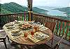 ... on the wrap-around deck is another casual dining area. With roof protection, this is the perfect spot for early morning breakfasts or late afternoon snacks.