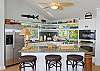 Everyone will love this spacious kitchen. This bright and cheery room stays cool while you prepare an island style meal for your family. The granite counters, stainless steel appliances, in-island fridge and bread drawers, and fun serving dishes are just the beginning. Cooking with an ocean view is so rewarding!