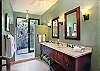 Beautiful his and her's vanity space with luxury outdoor shower.