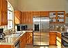 The kitchen is conveniently located just inside the great room, with newly installed stainless steel appliances.