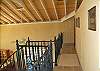 Back inside at the top of the spiral staircase is the upper sleeping level at Christy Ann. Two separate sleeping rooms on this level are positioned at either end of a long hallway.