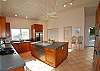 The large modern kitchen is a dream for any chef. Accented with rich mahogany cabinetry and granite Corian countertops, it's equipped for preparing the finest feast. Stainless steel double convection ovens, built-in microwave, dishwasher, blender, toaster oven... this kitchen has it all!