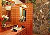 This bath with a large stone shower and skylight is adjacent to the West bedroom.