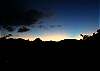 The sun sets over the mountains at Great Turtle Villa, but the sunsets are still spectacular. Once the sun sets, the clouds glow as the countryside moves into evening.