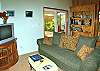 While it is doubtful you will want to spend much time here, the living room boasts comfortable seating, a small library and even an i-pod docking station.