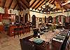 Inside, the Great Room features cozy mahogany and Sea Grass furniture...
