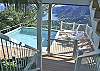 Nearby stairs lead down to the pool level where gates swing closed for pool safety. The decking on both levels is a high-tech composite product using no screws or nails to stub toes!