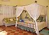 The tropical and airy feel of this bedroom are added benefits to the privacy and beautiful views.
