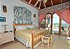 This poolside bedroom suite has a full bath and is furnished with a king sized bed and a tropical marine motif.