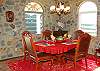 The inside dining area has seating for six-enjoy a formal dining experience amidst local hand -laid stonework and inviting arched windows.