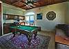 Enjoy a game of pool or darts in this fully air-conditioned and screened room. The 7' pool table makes a striking centerpiece while the two pillow-tossed, twin-size daybeds enable the capability of another bedroom. A wet bar and mini refrigerator are available for your convenience.