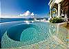 The pool is 16' x 32' x 5' deep, with an 8' x 12' x 6-inch deep platform within pool (perfect for smaller children) + built-in 8-foot circular hot tub which spills over into pool.