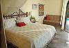 Below, the Poolside bedroom with its airy bath and 10' ceilings, has an extra sitting area with a sleeper sofa which folds out to a full-size bed.