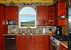 Each facet of the kitchen is well thought-out from the lighting above the sink, to the exhaust fan over the gas stove. The stone backsplash adds character and personality to the kitchen
