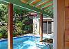 The 10'x16' swimming pool is solar-heated for comfort year-round. A pool shower is hidden around the corner near a small bamboo grove. The master bedroom suite faces the pool and extraordinary vista beyond.