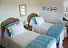 The closest bedroom has two twin beds that can easily be converted to a king bed. The decor is simple yet pleasing, designed for island living.