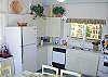 The cottage style eat-in kitchen is fully enclosed and equipped to cook every meal.