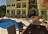 As you enter the paved courtyard, lays the pool area overlooking a picture postcard panorama of sky and sea, with a mini-bar and chaise lounges for cocktails, sunning and admiring the ocean view beyond.
