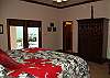 Relax here in this comfortable bedroom and watch the sunrise over the hillside.