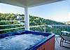 A long covered deck spans the entire width of the property. The spa lounge is located on the other end of the upper deck- off  the dining area.