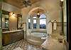...and the master bath. Decorated in Moroccan tiles and custom made vanities, this gorgeous bathroom offers a steam shower as well as an inviting bath tub. Molton Brown amenities, bathrobes, slippers, and blow dryer are provided for your comfort and convenience.
