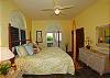 A king sized bed graces the master bedroom with its slate tile floors and ensuite bath. French doors lead to the lower veranda which is linked to the upper level by a gardenside stairway.