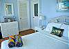 This poolside bedroom suite is light and colorful with a queen-sized bed.