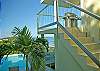 Steps directly from the lower level deck leads to the swiming pool below. Trex decking has been added for guest comfort.