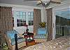 Each bedroom is air-conditioned and has comfortable seating areas. This bedroom has draperies to keep the morning sun out, so you can sleep late.