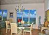 Luminaria's glass dining table seats 6-8 and overlooks pristine views of Coral Bay. A beautiful hand painted oriental screen and floral chandelier add to the ambiance of this gracious dining area.