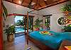 Inside the master bedroom suite serenity meets comfort. It all begins with this beautiful hand-carved, Teak queen-sized four-poster bed. Carefully crafted lighting and uncluttered surroundings set the mood for both romance and relaxation.