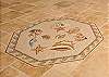 ...Travertine tiled floors with a custom mosaic medallion...