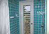 The master bedroom shower has a huge wrought iron and screen garden window. In this one, a door in the shower leads to an outdoor shower area for those who must have their views!