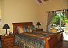 Both queen bedrooms have interior entrances and views of the gardens and pool area.