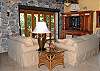 The entertainment center with flat screen satellite TV is housed in another corner of the great room. Doors can open up for seamless inside-outside living with or without screens.