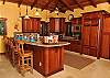 The state of the art kitchen features granite counters and backsplashes,a farmhouse sink with copper fixtures and quality appliances.