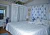The master bedroom suite is just steps away with its king-sized bed. Both main level bedrooms have air conditioning and ceiling fans too.