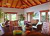 Lush greenery and tropical furniture sooth the senses. On three sides, oversized mahogany-framed screens ensure continuous tropical breezes.