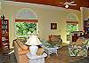 Inside, the great room is light and airy with oversized windows, elegant ceiling fans, and thoughtful decorative touches.