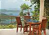 Perched in a corner, an outdoor dining table is a perfect spot for early morning coffee.