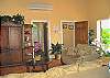 The great room is light and airy with high ceilings, air conditioning and views of the lush garden area and courtyard.