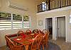 Just beyond lays the formal dining area, with seating for six. Overhead a split air conditioning unit stands ready for those rare days when the tradewinds and ceiling fans just aren't enough.