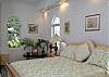 The fourth bedroom has a florid flair, a king bed, and adjoining bathroom.
