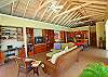 The comfortable great room contains tasteful furniture and high ceilings.