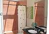 The guest bathroom boasts tropical colors of lime and crème. The huge walk-in shower and screened ceiling- with views of the stars during the evenings and blue skies during the day- will soothe all troubles away...