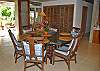 Just inside, hallways lead to the  main house's two bedroom wings. An elegant glass dining table, with seating for six graces a portion of the great room.