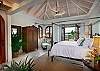 Twin mahogany staircases ascend from either side of the family room to À La Mer's upper floor, where five more air-conditioned bedroom/suites overlook the pool and majestic yachts riding at anchor on sparkling Great Cruz Bay.